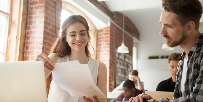 two people looking at papers