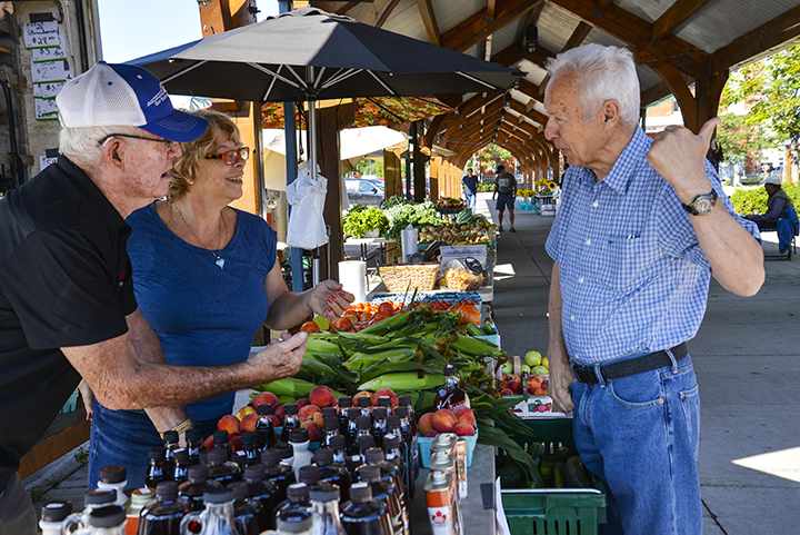 Belleville Farmers Market vendors chatting with a customer