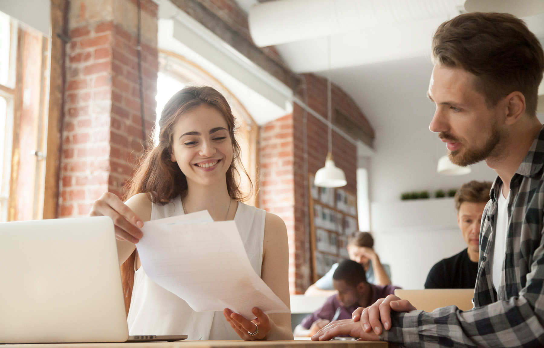 photo woman and man looking over papers at desk