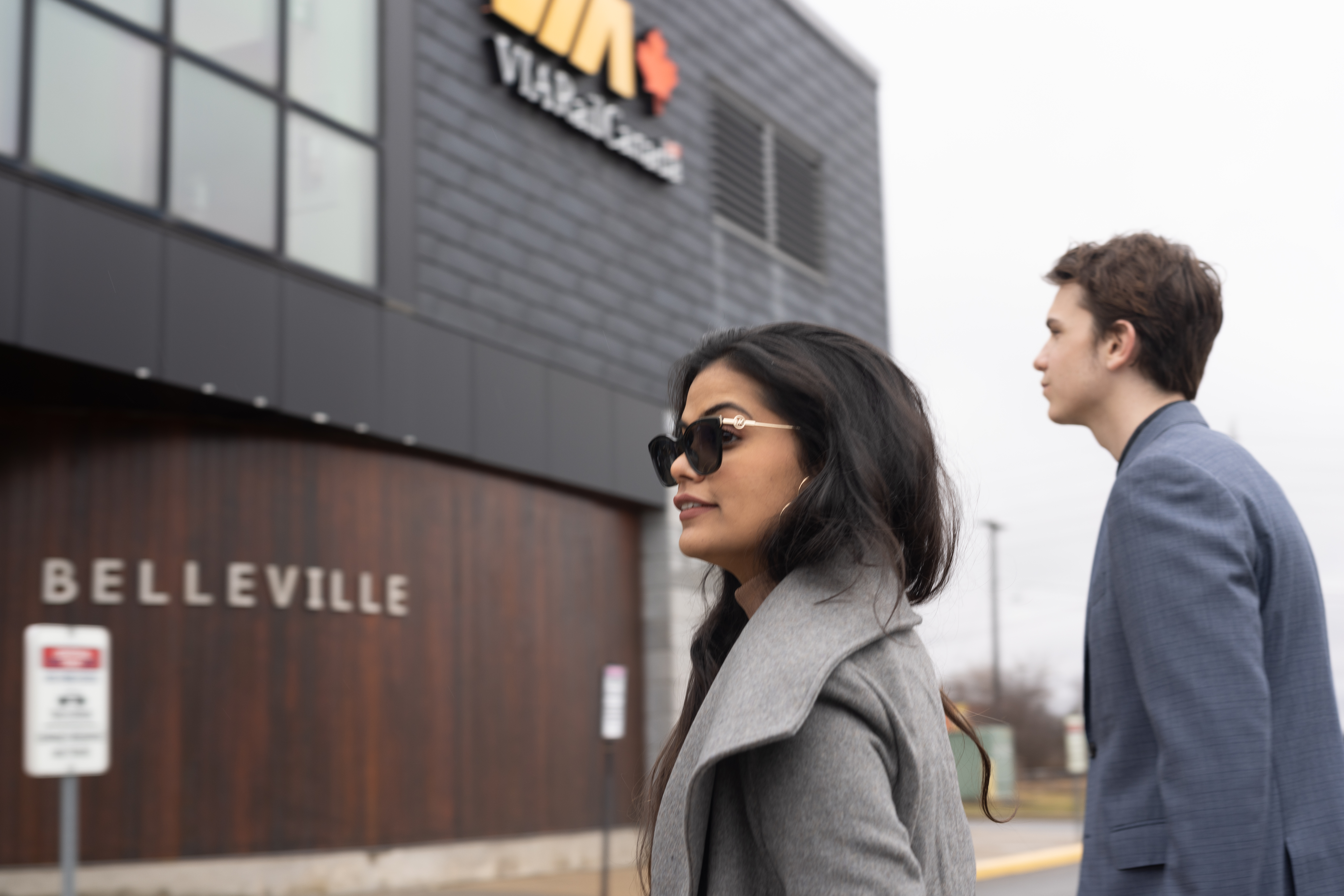 Two people walking into Train station