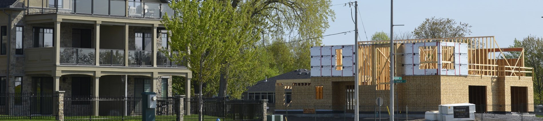 Photo showing a new house build and an existing home