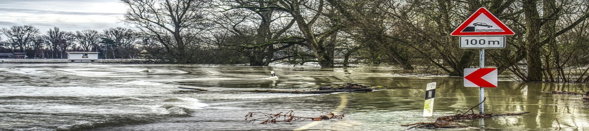 Flooded roadway with submerged traffic sign