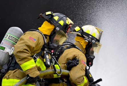 firefighters with hose line