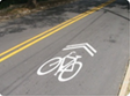 Painted sharrow symbol on roadway