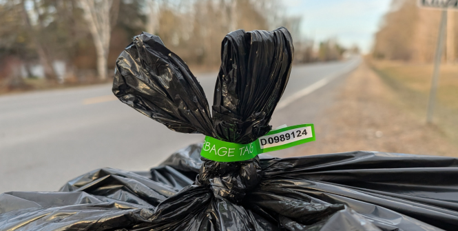 Image of a garbage bag with a green bag tag.