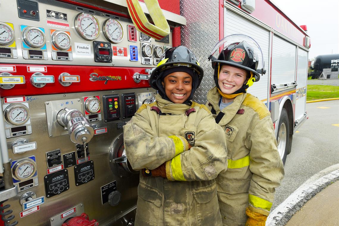 Girls standing in front of fire truck