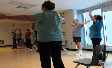 women and men exercising in a fitness class