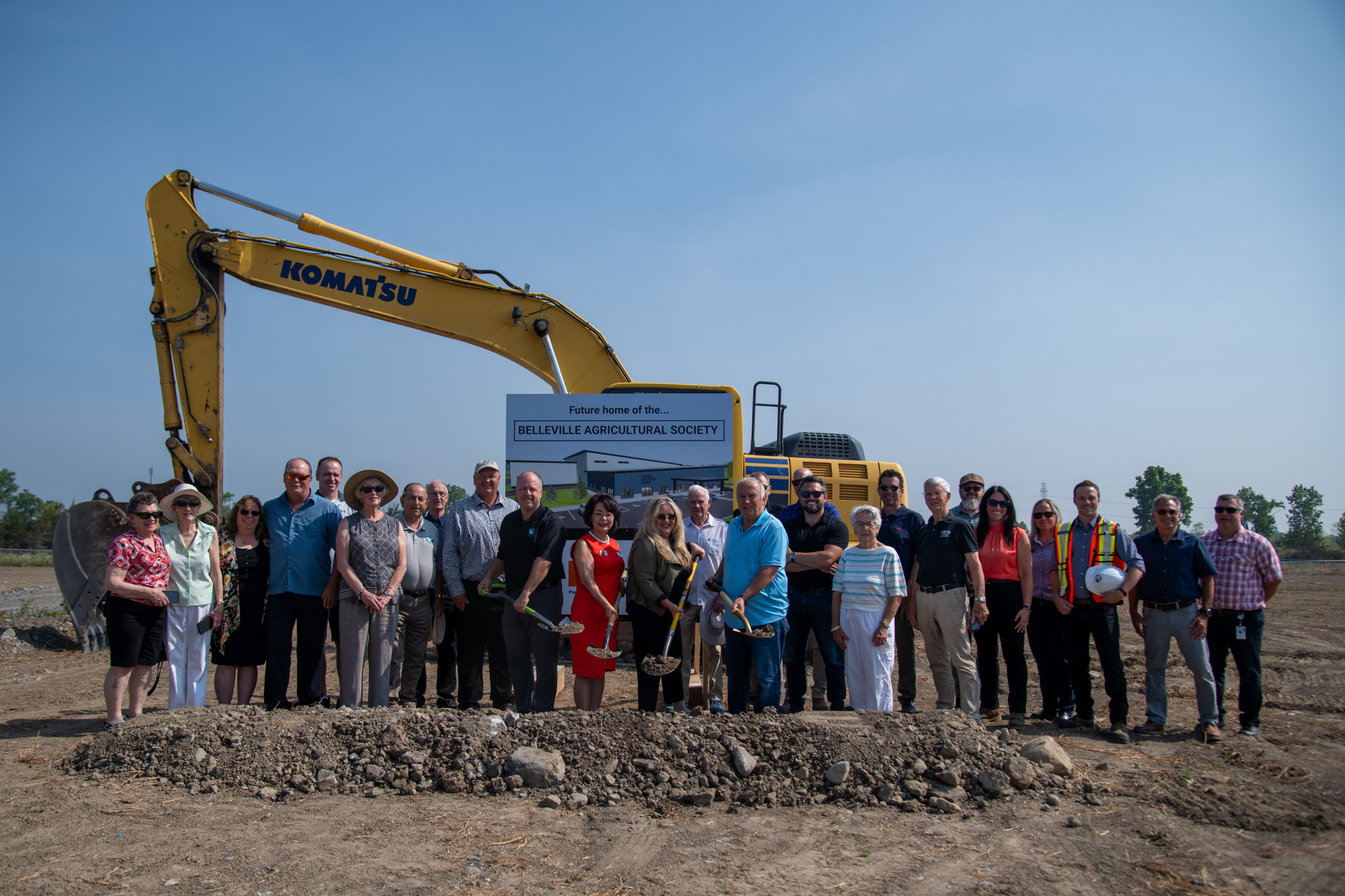 Group of people standing together infront of groundbraking site