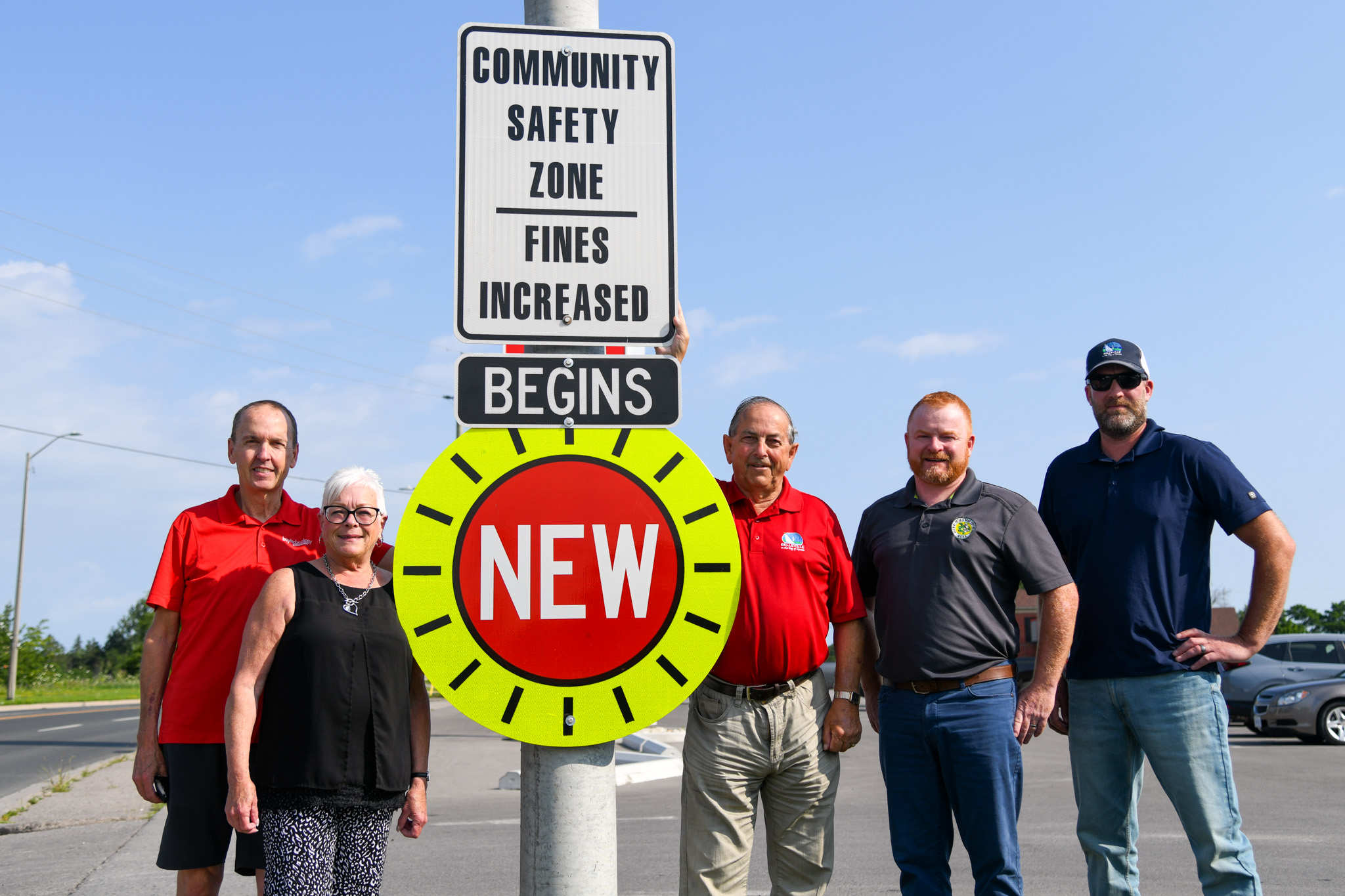 Photo of the Belleville Transportation Committee standing by a new Community Safety Zone sign.