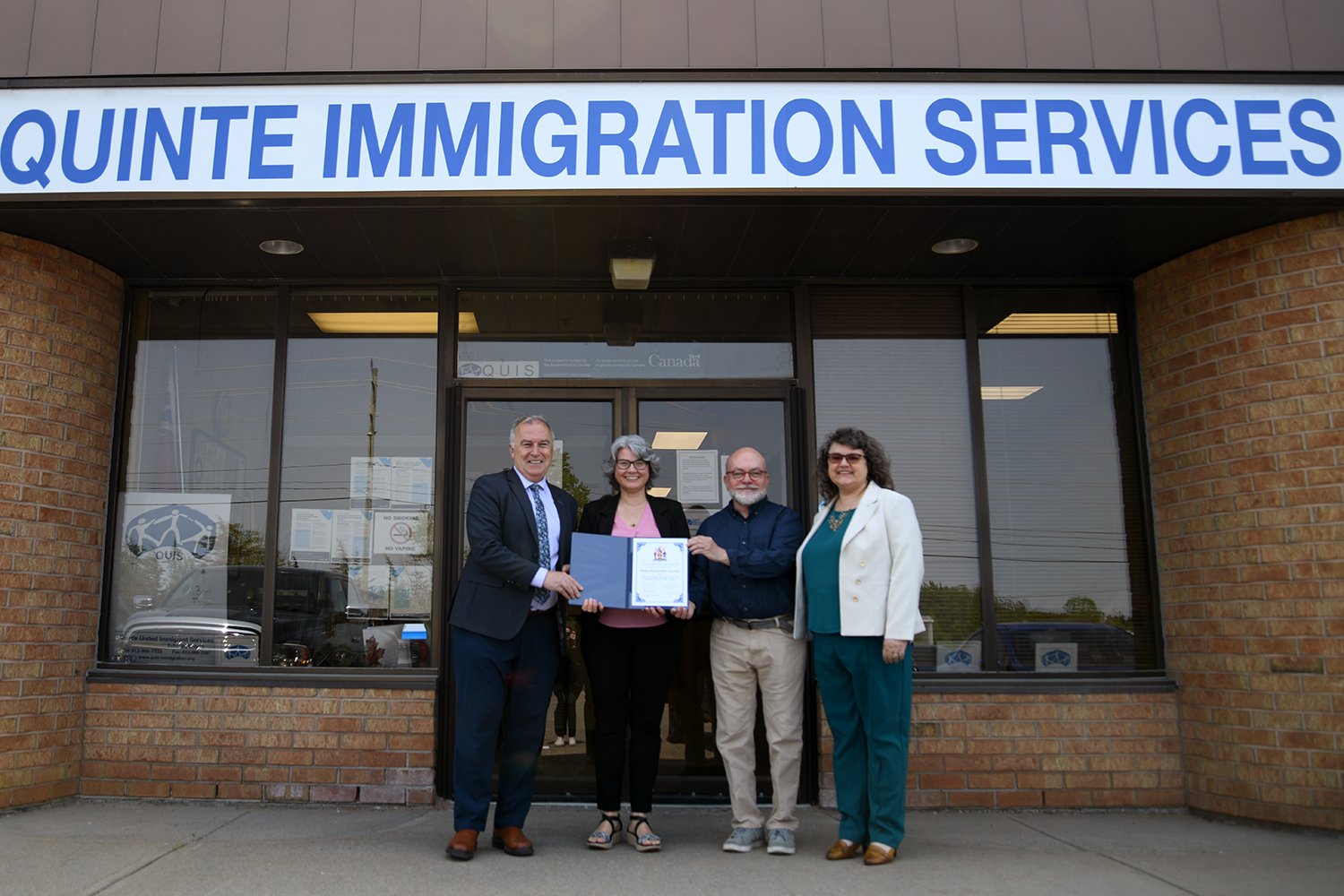 Photo with the Mayor Ellis and Quinte Immigration Services holding the sign Workplace Inclusion Charter.