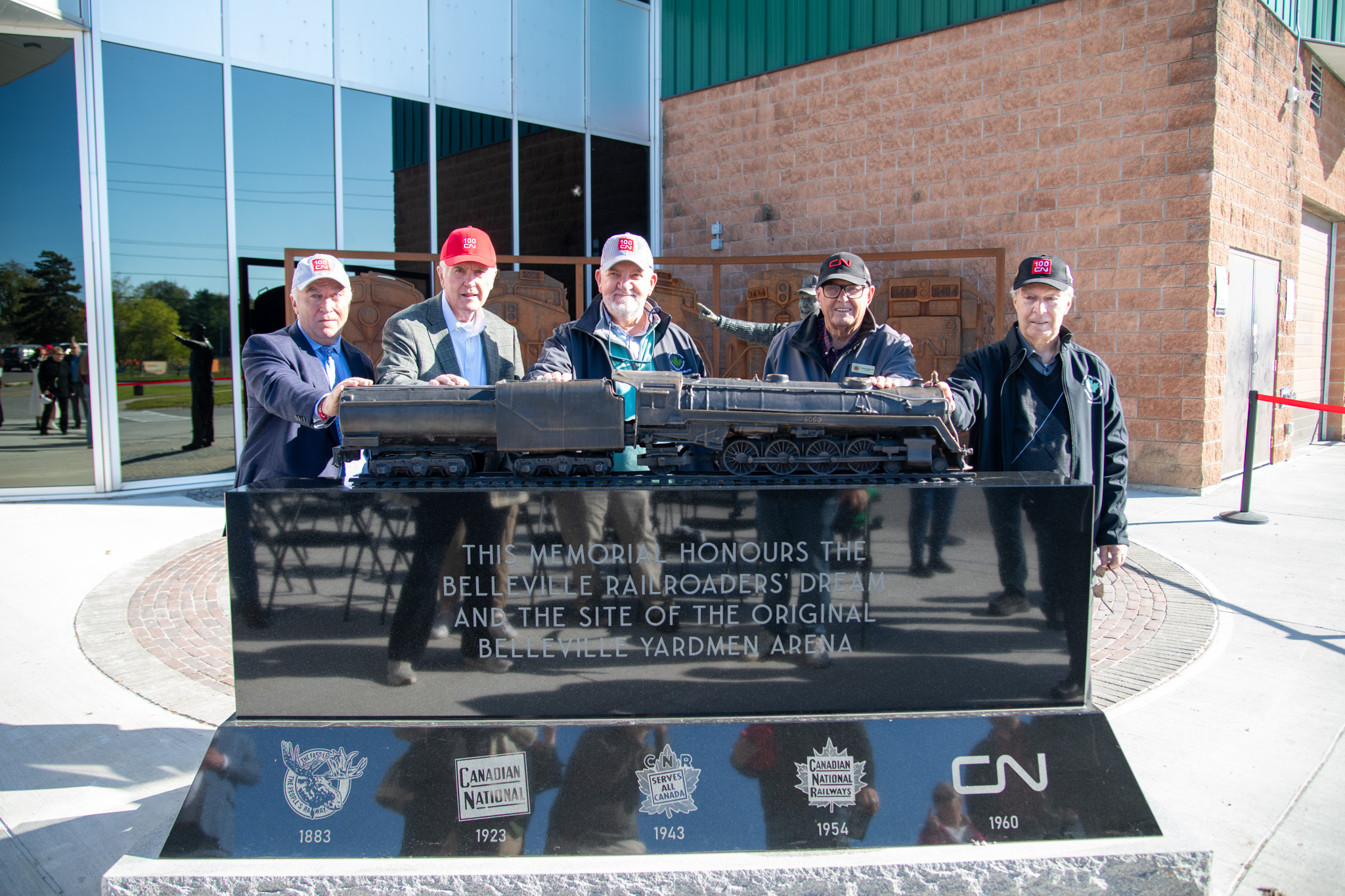 Representatives of the Belleville Yardman committee stand in front of the display
