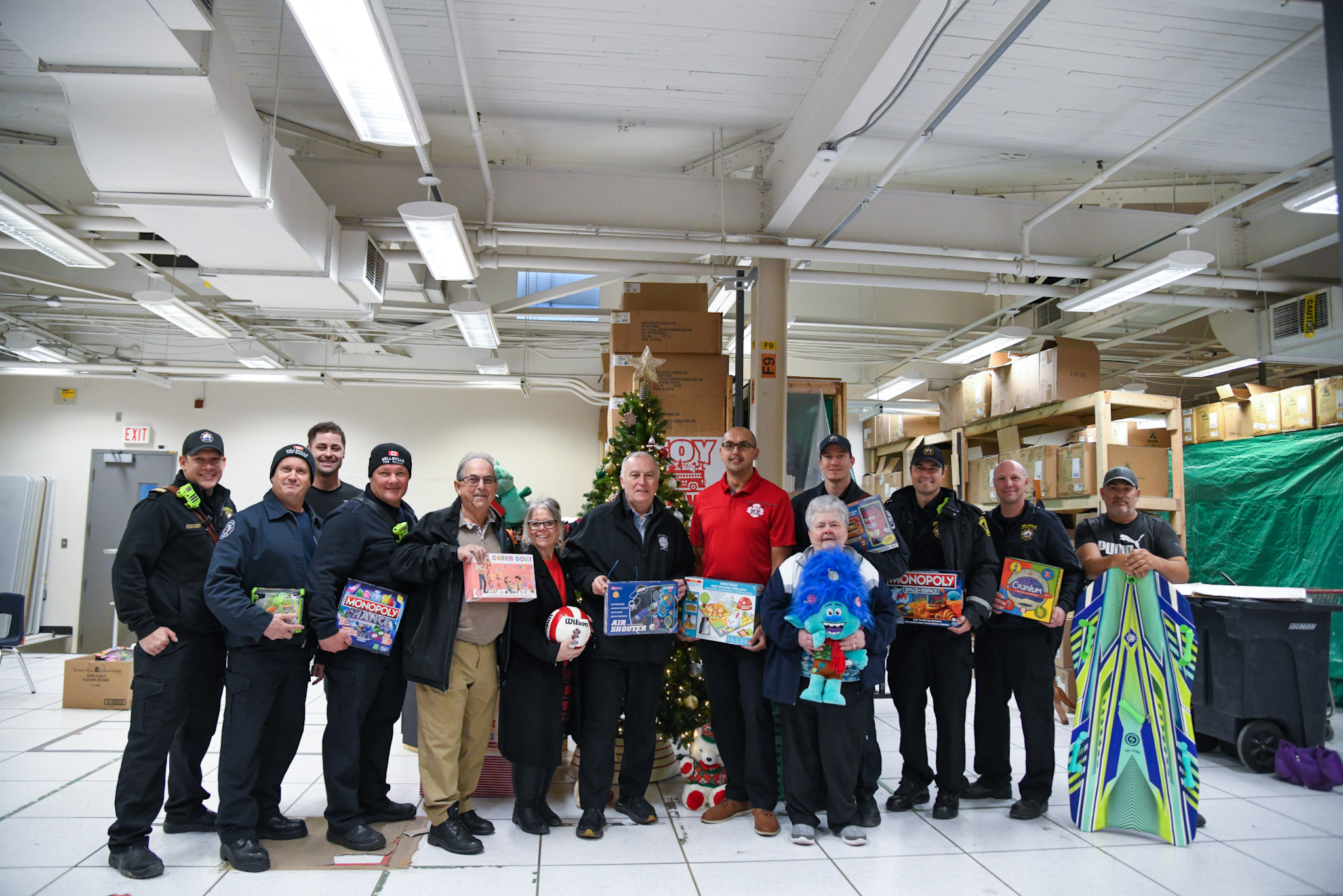 Mayor, council and Belleville firefighters holding toy donations 