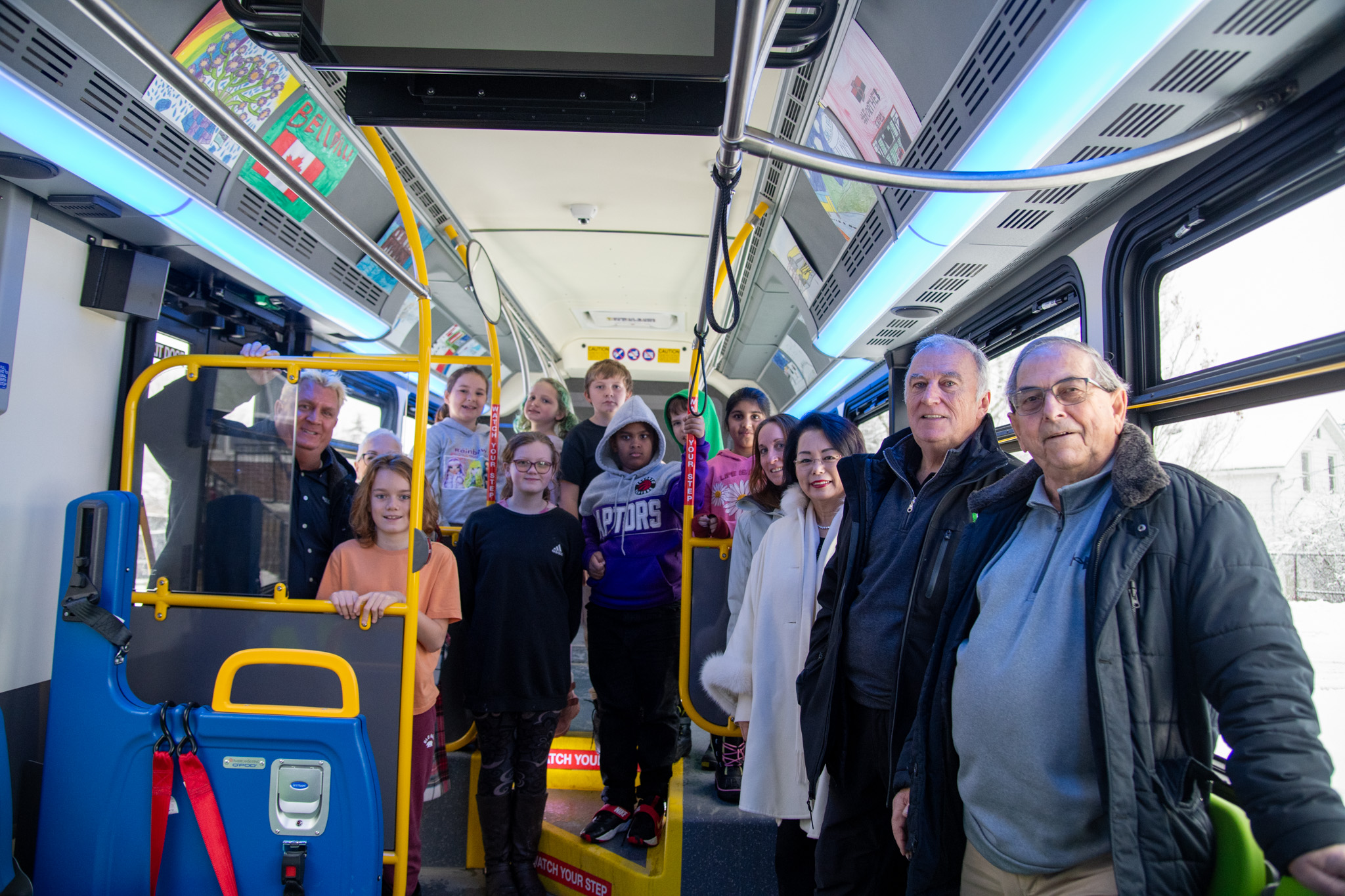 Students from Prince Charles Public School show off artwork on City bus alongside Mayor Neil Ellis and Councillor Garnet Thompson