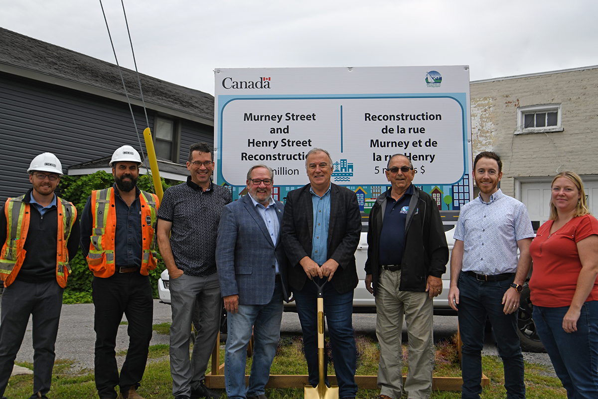 Mayor, Council and project team standing in front of the sign for the Murney and Henry Street project.