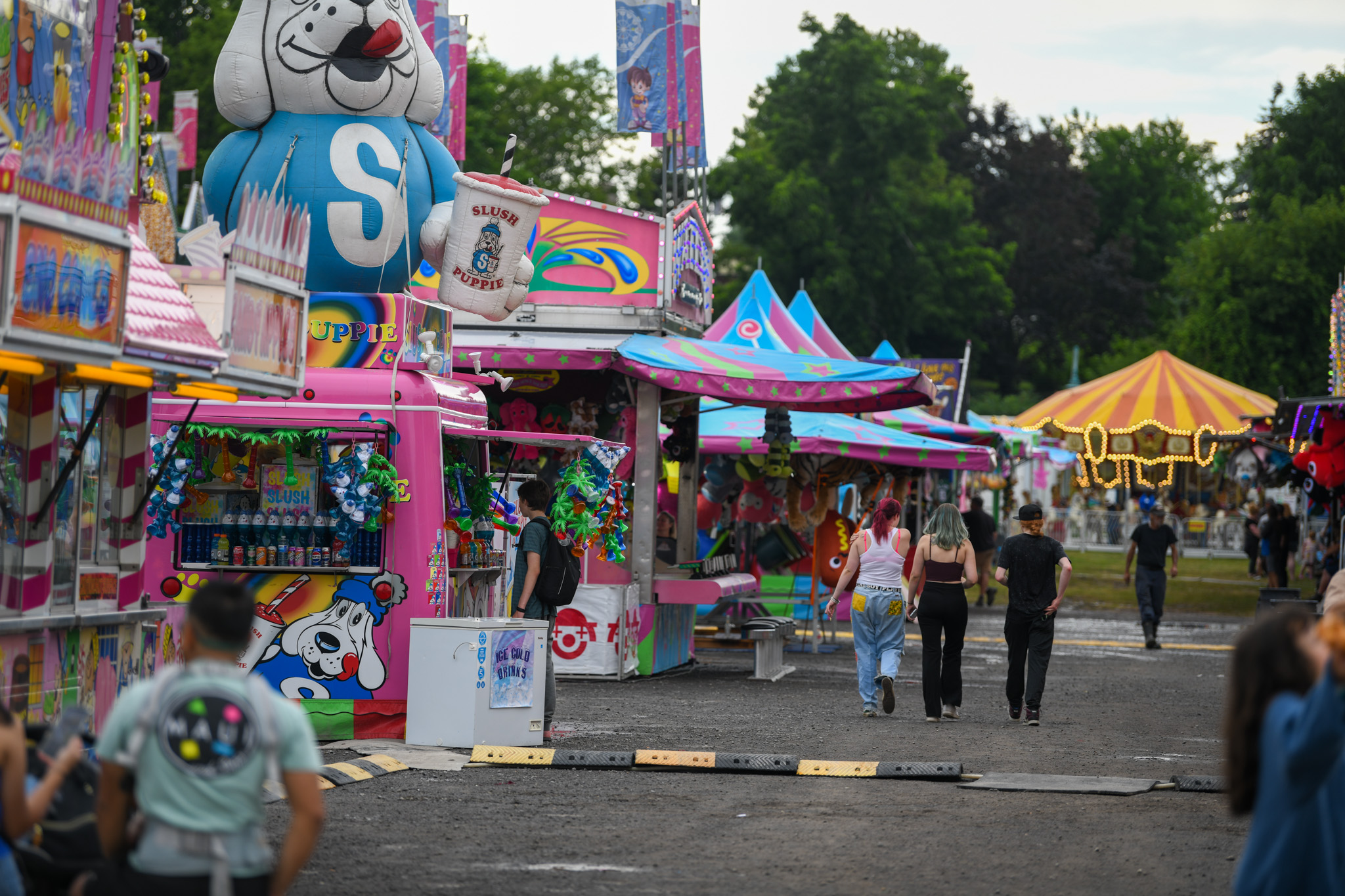 people walking through midway full of games