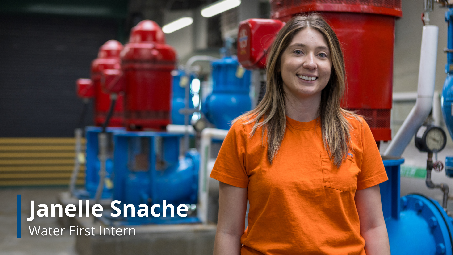 A photo of Janelle Snache, a Water First Intern, at the water treatment plant with machines used to treat water in the background.