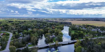 Bridge running across Moira River with open fields in the background