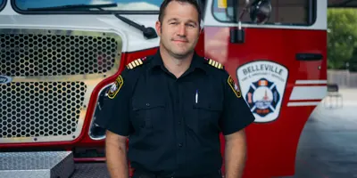Kyle Christopher standing in front of BFES truck