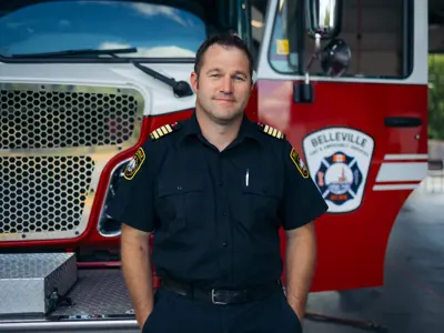 Kyle Christopher standing in front of BFES truck