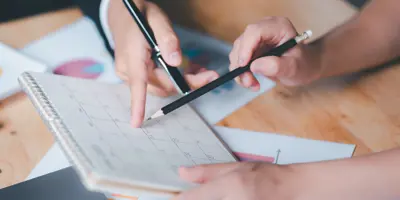 People writing on a calendar