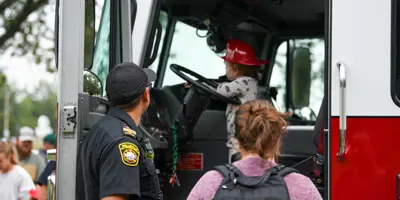 Child exploring Belleville Fire truck during Touch a Truck event
