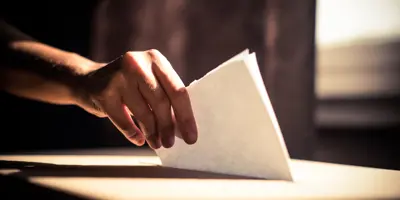 Person putting ballot in box