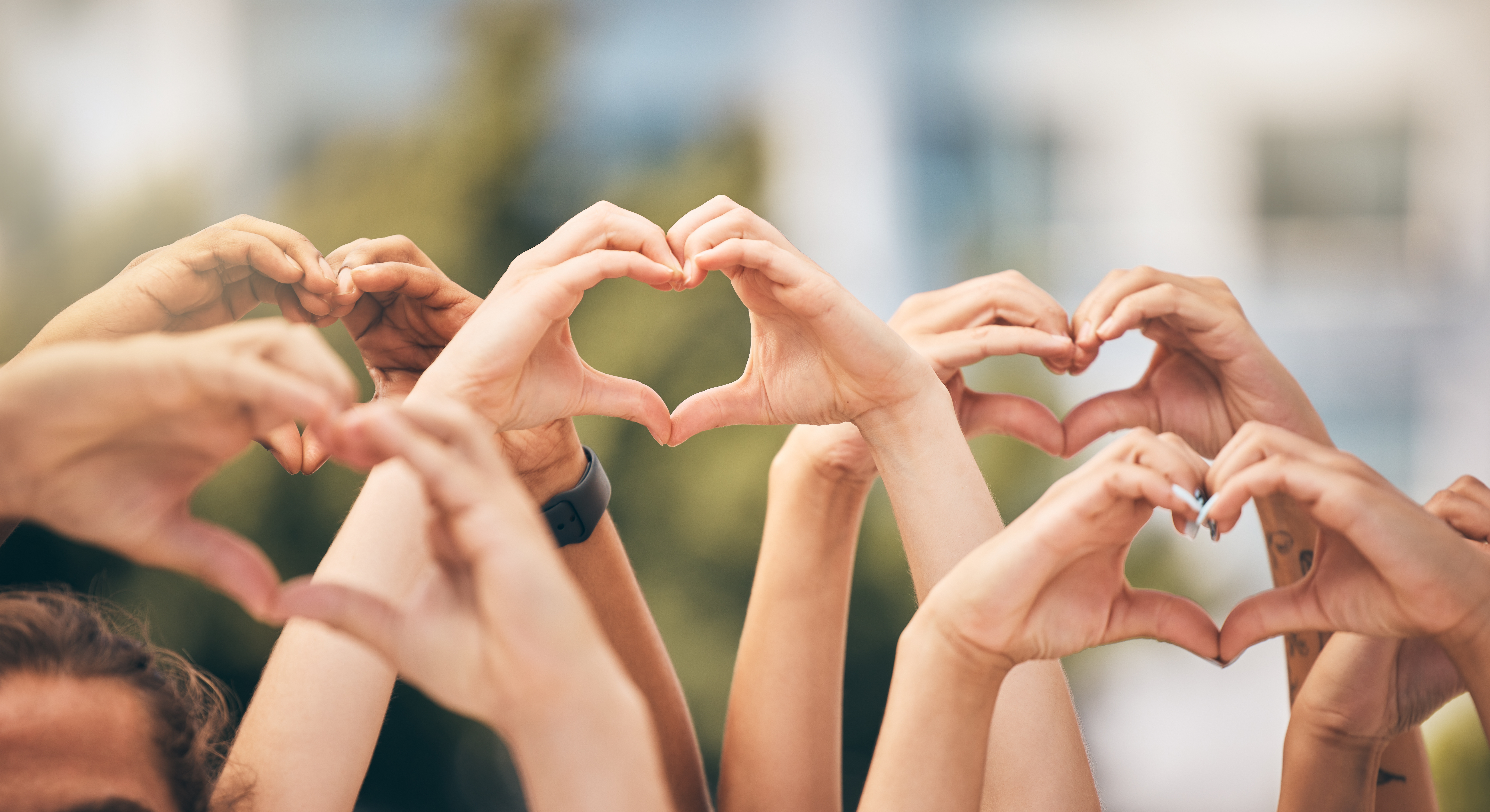 People making hearts with their hands