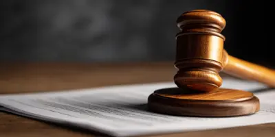 Gavel rests on stack of paper documents