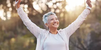 Woman with hands raised above head