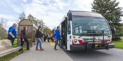 People boarding a transit bus.